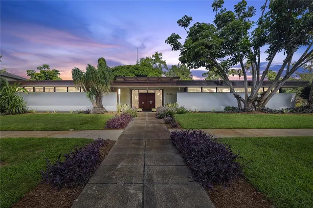 a front view of a house with garden