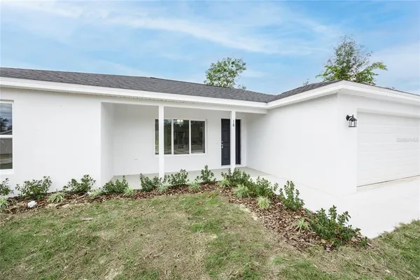 a view of a house with potted plants