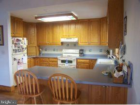 3 Harbor Point Lewes, DE 19958 - Photo 2 of 12 a kitchen with stainless steel appliances granite countertop a stove a sink and a refrigerator