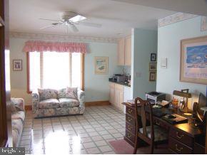 3 Harbor Point Lewes, DE 19958 - Photo 6 of 12 a living room with furniture and a chandelier