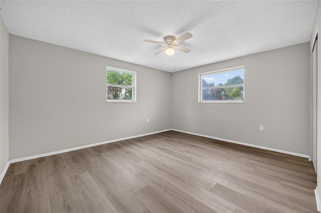 1012 Prescott Lane Holiday, FL 34691 - Photo 20 of 45 a view of an empty room with wooden floor and a window