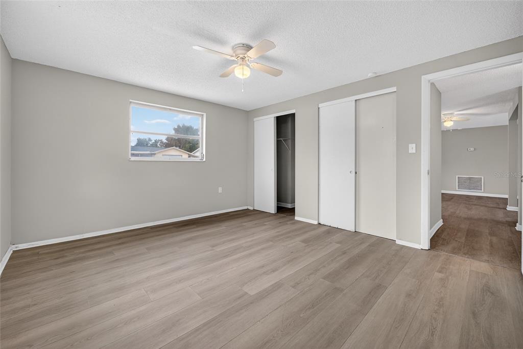 1012 Prescott Lane Holiday, FL 34691 - Photo 21 of 45 a view of an empty room with wooden floor