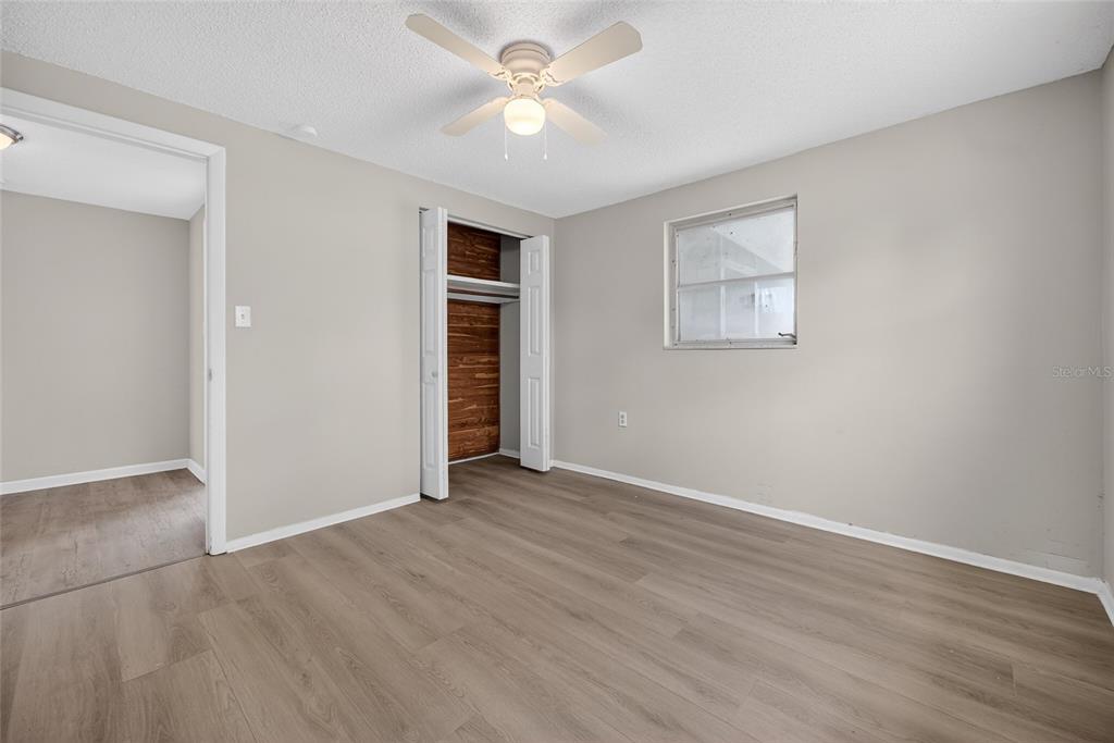 1012 Prescott Lane Holiday, FL 34691 - Photo 24 of 45 an empty room with closet and a ceiling fan