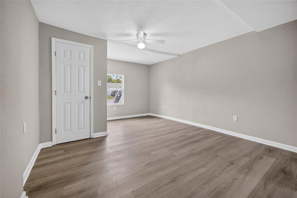 1012 Prescott Lane Holiday, FL 34691 - Photo 25 of 45 a view of an empty room with wooden floor