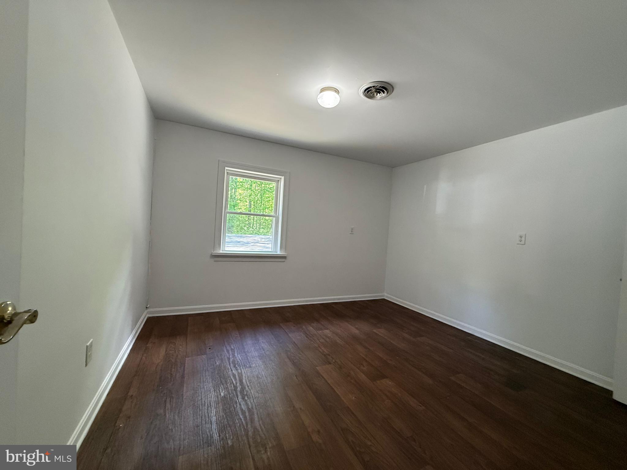 2315 Oak Park Road, Unit B Madison, VA 22727 - Photo 7 of 7 an empty room with wooden floor and windows