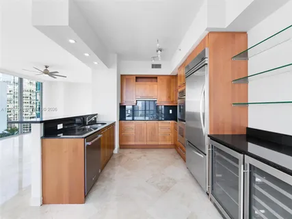 an empty room with fan and windows