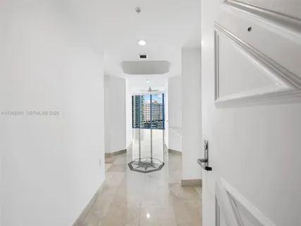 a large kitchen with kitchen island granite countertop a refrigerator and stove