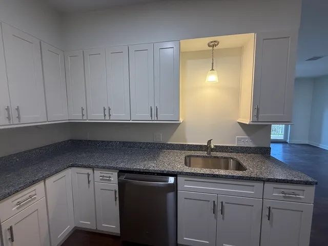 a kitchen with white cabinets and a sink