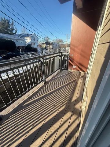 a view of balcony with wooden floor