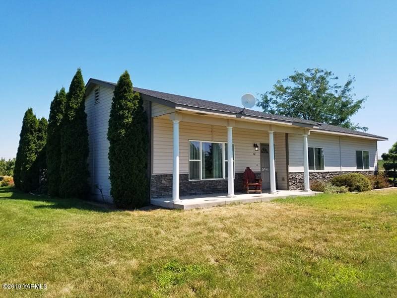 461 Puterbaugh Road Grandview, WA 98930 - Photo 1 of 27 a view of a house with backyard outdoor seating and hardwood
