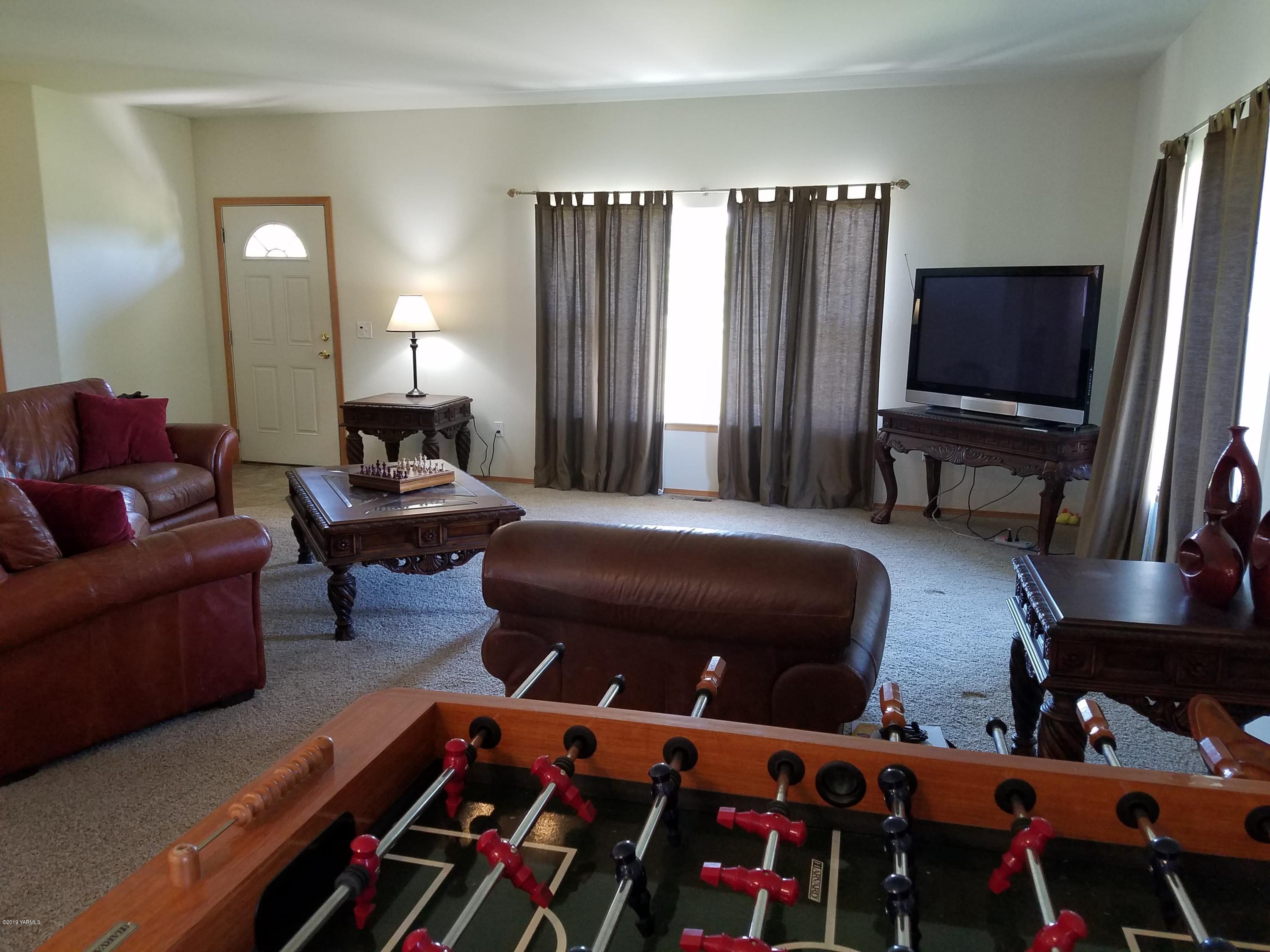 461 Puterbaugh Road Grandview, WA 98930 - Photo 10 of 27 a bedroom with furniture and a flat screen tv