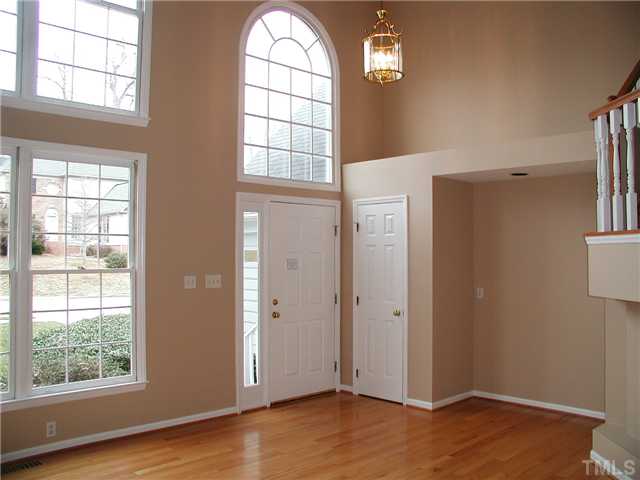 2324 Florida Court Raleigh, NC 27615 - Photo 2 of 17 an empty room with wooden floor cabinet and windows