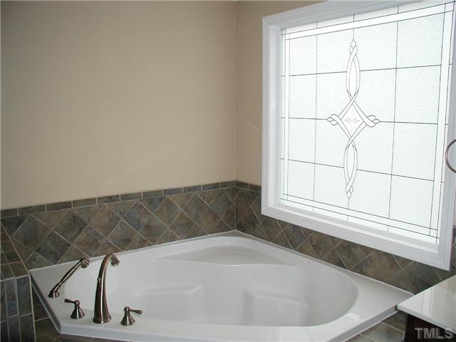 2324 Florida Court Raleigh, NC 27615 - Photo 11 of 17 a bath tub sitting in a bathroom next to a window