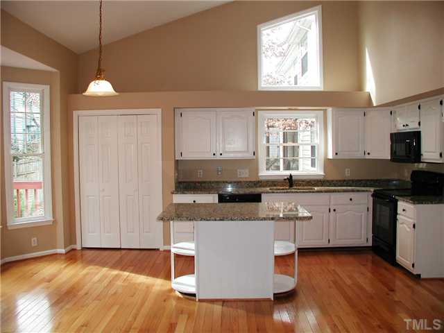 2324 Florida Court Raleigh, NC 27615 - Photo 6 of 17 a kitchen with stainless steel appliances granite countertop wooden cabinets a window a sink and a stove