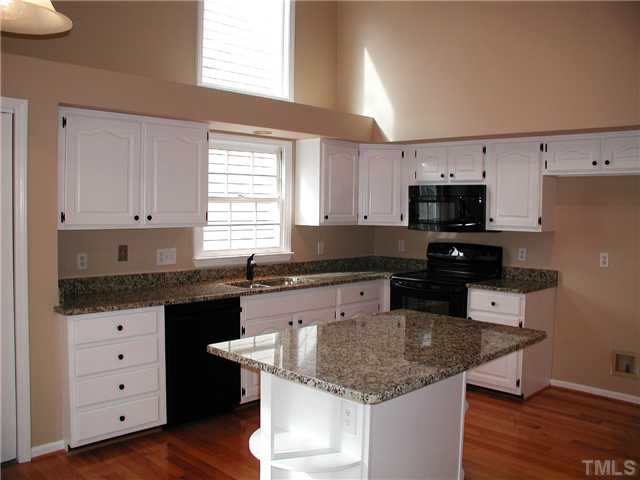 2324 Florida Court Raleigh, NC 27615 - Photo 7 of 17 a kitchen with granite countertop a sink and a stove top oven