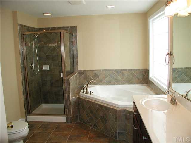 2324 Florida Court Raleigh, NC 27615 - Photo 10 of 17 a bathroom with a sink a toilet and shower