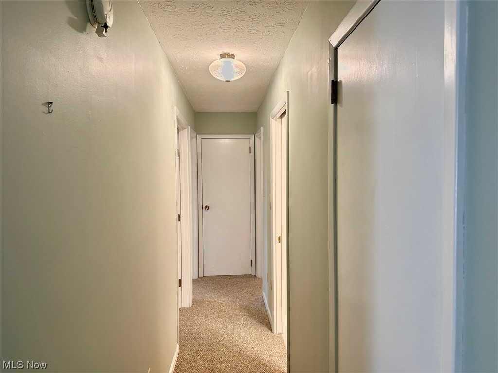 1009 Sandy Lake Road Kent, OH 44240 - Photo 12 of 35 Hallway from living room to 3 bedrooms and full main bath