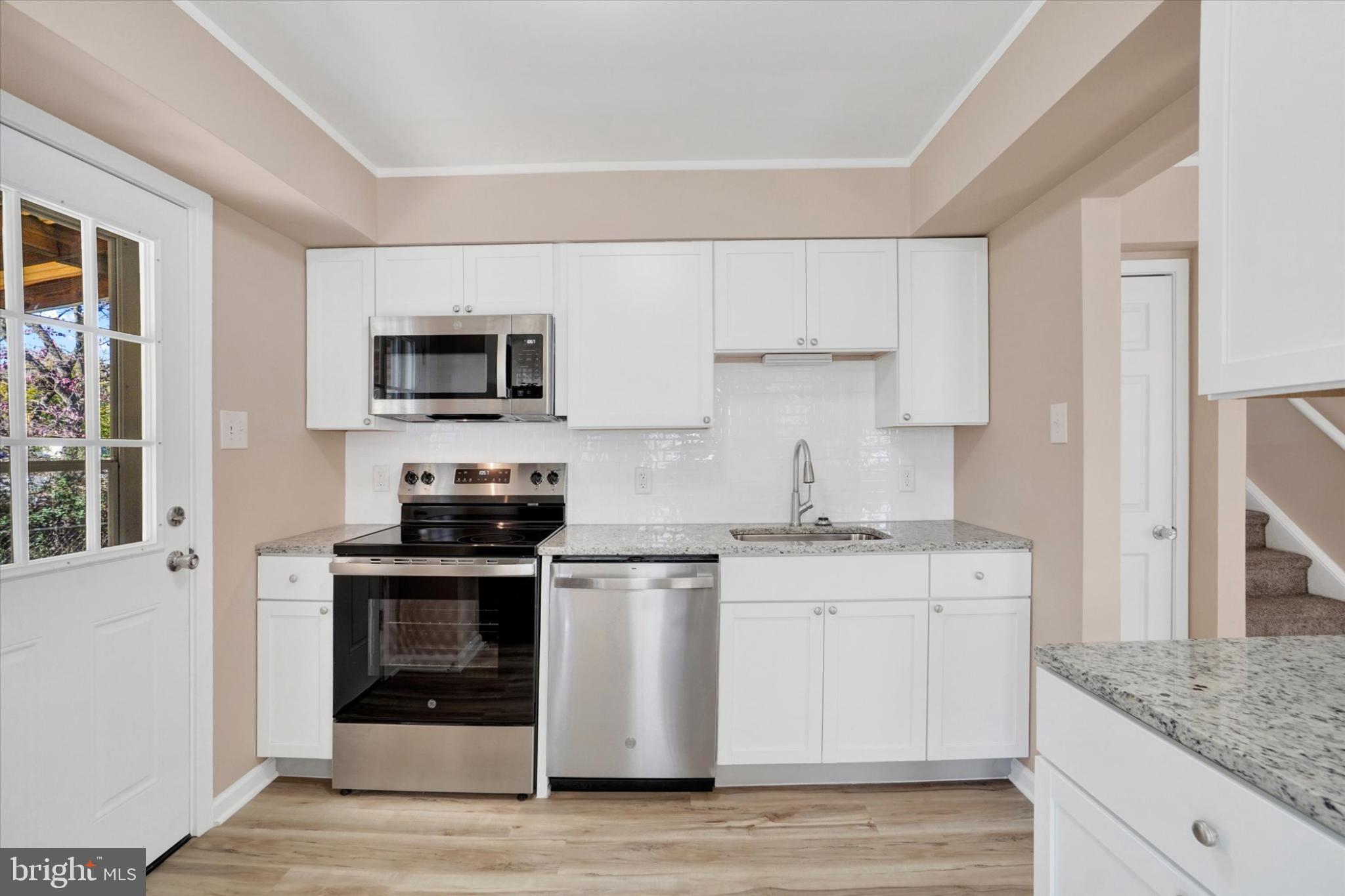 1212 Livingstone Road York, PA 17404 - Photo 4 of 24 a kitchen with stainless steel appliances granite countertop a stove and a sink