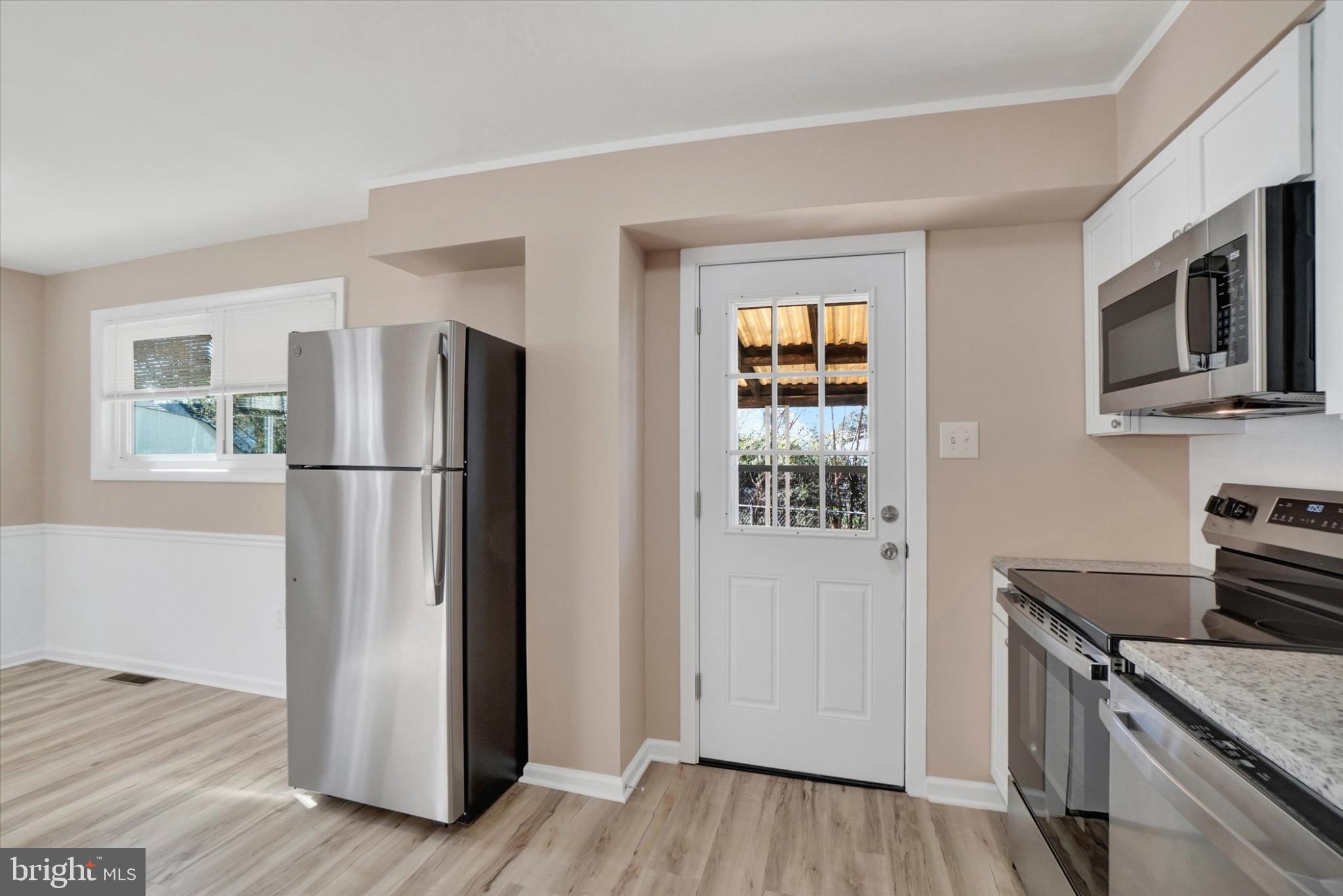 1212 Livingstone Road York, PA 17404 - Photo 6 of 24 a kitchen with stainless steel appliances granite countertop a refrigerator microwave and stove top oven
