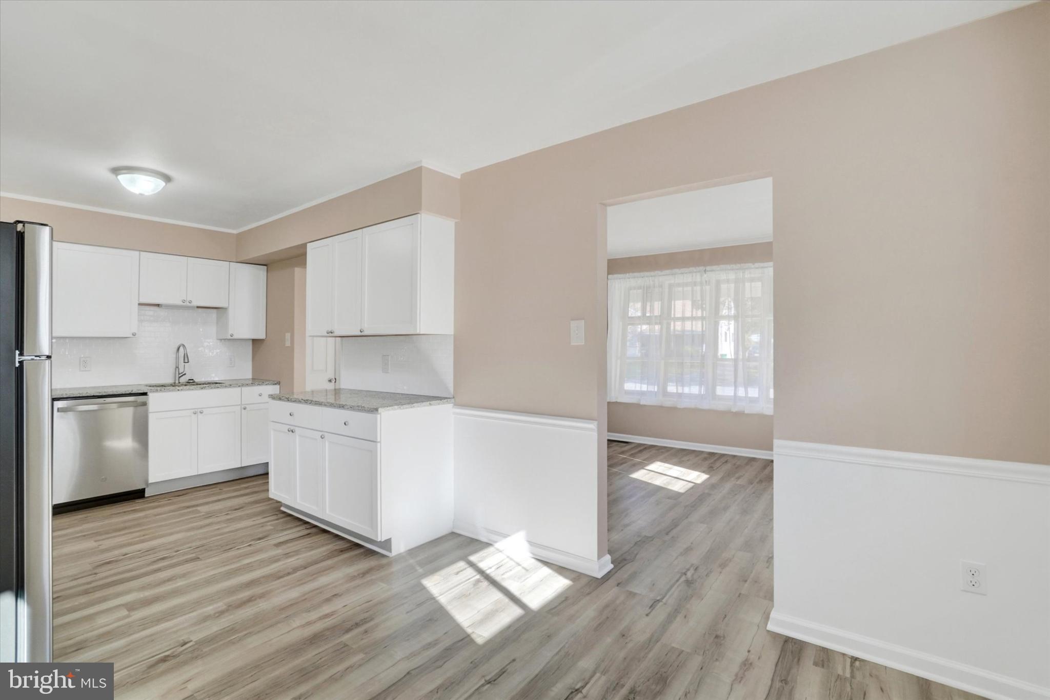 1212 Livingstone Road York, PA 17404 - Photo 8 of 24 a large white kitchen with wooden floors and white stainless steel appliances