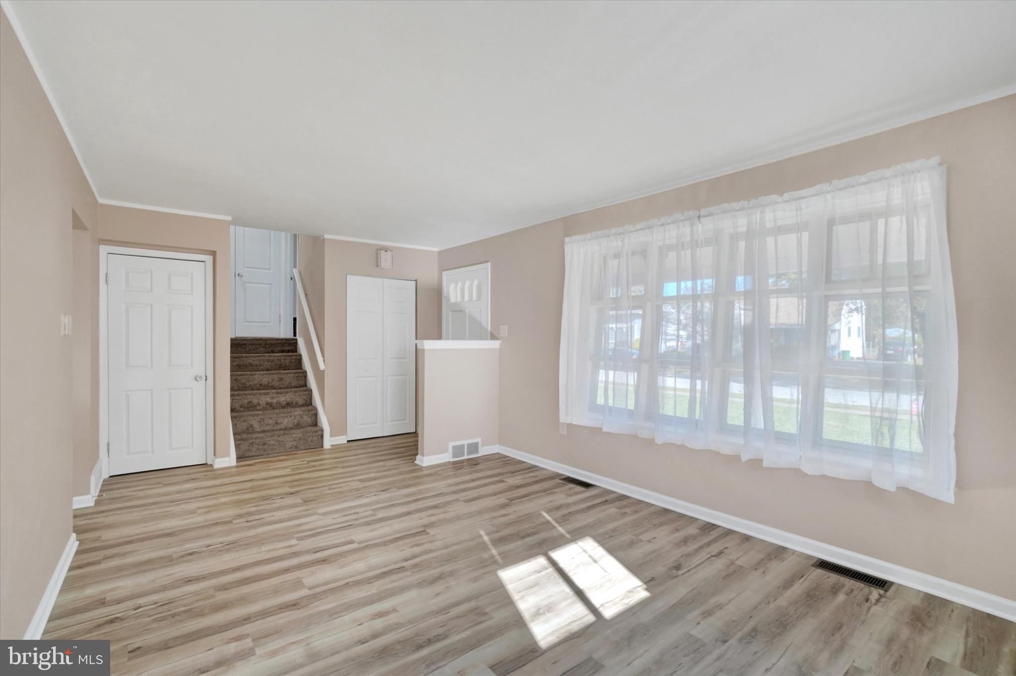 1212 Livingstone Road York, PA 17404 - Photo 9 of 24 a view of an empty room with wooden floor and a window