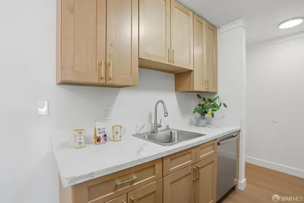 a kitchen with stainless steel appliances granite countertop white cabinets a sink and dishwasher