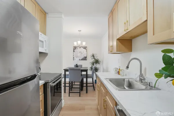 a kitchen with stainless steel appliances a sink and a stove with granite countertops