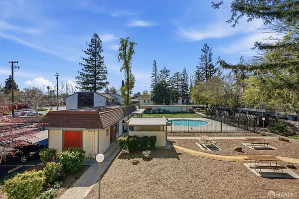 a view of a swimming pool with a patio and a yard