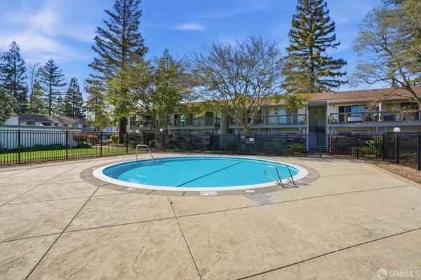 a view of a swimming pool with an outdoor seating and a yard