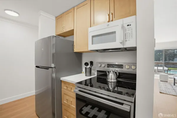 a kitchen with stainless steel appliances and cabinets