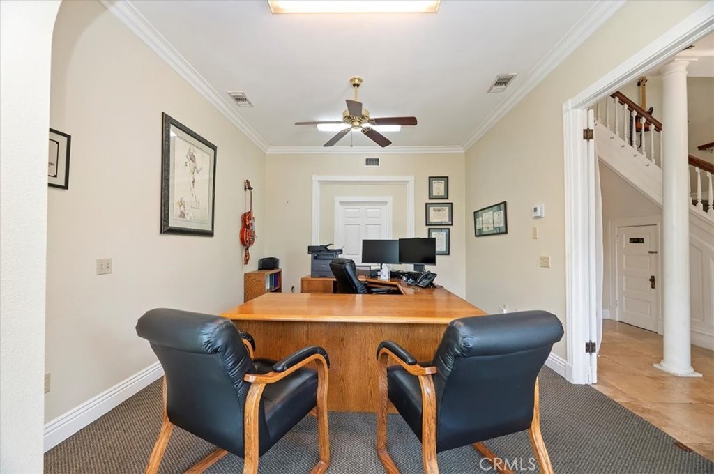 3845 Tenth Street Riverside, CA 92501 - Photo 13 of 45 a dining room with furniture a window and a chandelier