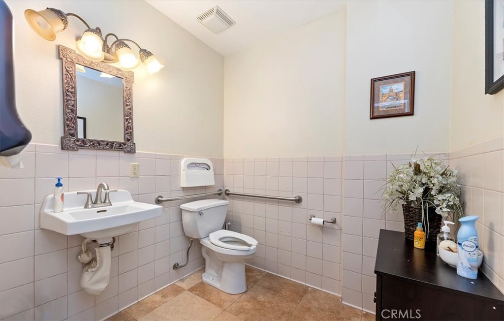 3845 Tenth Street Riverside, CA 92501 - Photo 19 of 45 a bathroom with a toilet sink and mirror