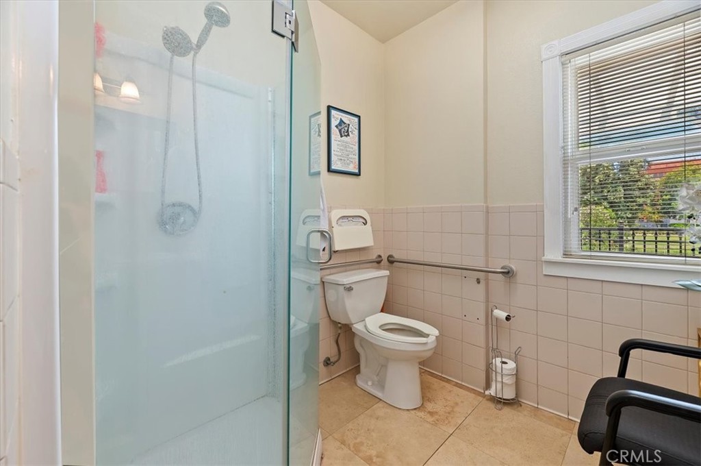 3845 Tenth Street Riverside, CA 92501 - Photo 33 of 45 a bathroom with a sink a toilet a window and vanity