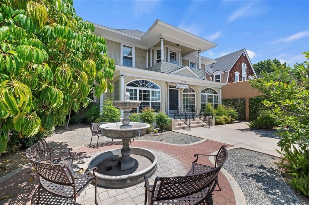 3845 Tenth Street Riverside, CA 92501 - Photo 5 of 45 a view of a patio with table and chairs potted plants and a bench