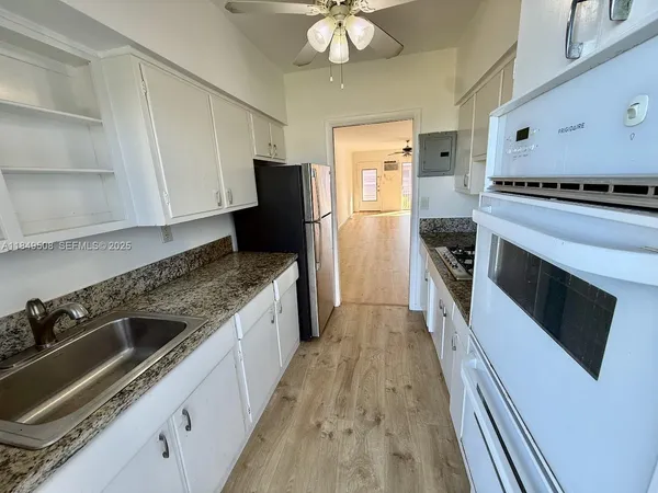 a kitchen with a stove a sink and a refrigerator