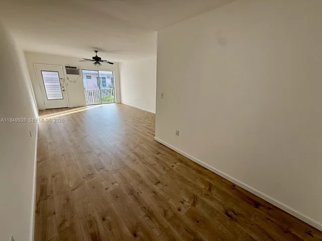 a view of a room with wooden floor