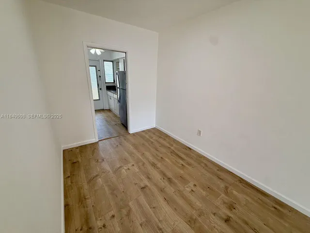 a view of empty room with ceiling fan
