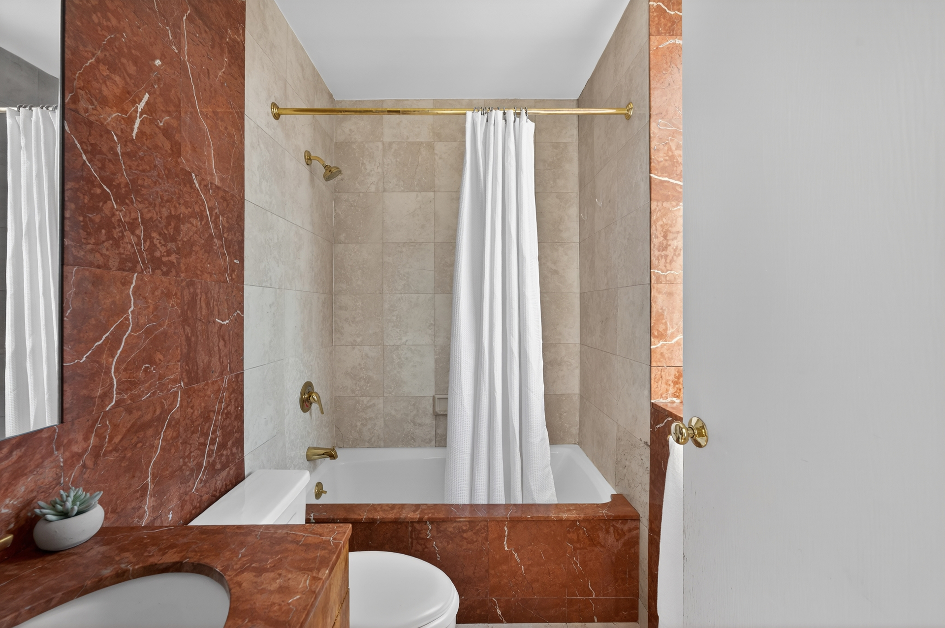 330 East 75th Street, Unit 28BC Manhattan, NY 10021 - Photo 11 of 17 a bathroom with a granite countertop sink toilet and shower