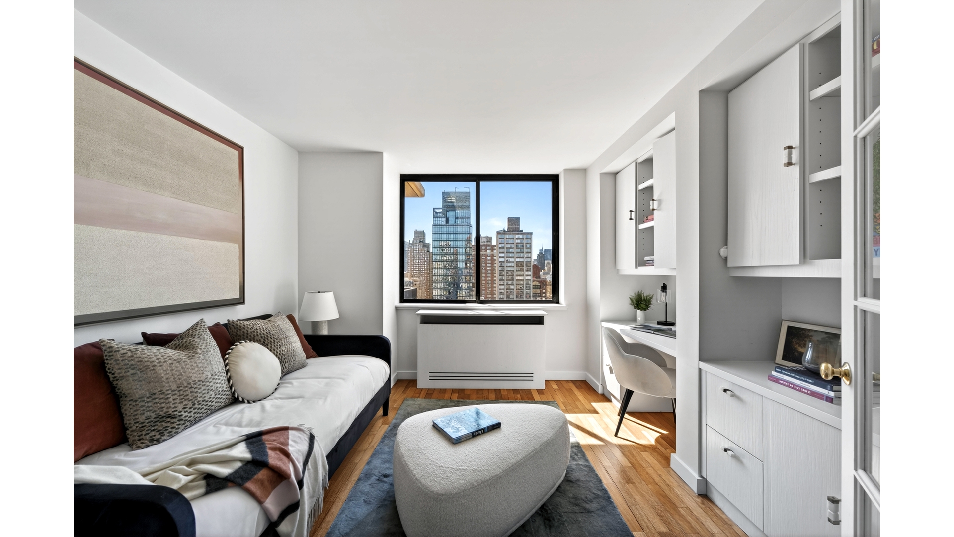 330 East 75th Street, Unit 28BC Manhattan, NY 10021 - Photo 12 of 17 a living room with furniture and a large window