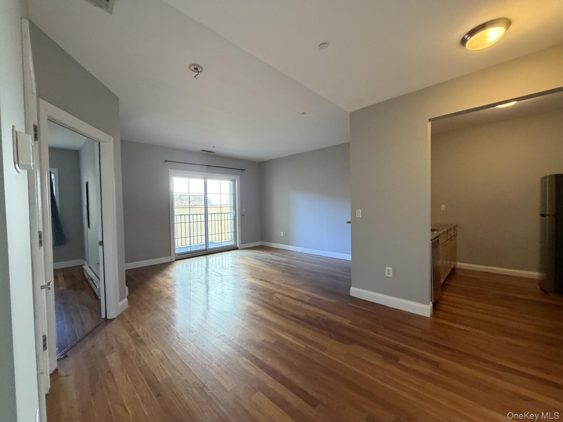 543 Main Street, Unit 204 New Rochelle, NY 10801 - Photo 2 of 17 a view of wooden floor and windows in a room