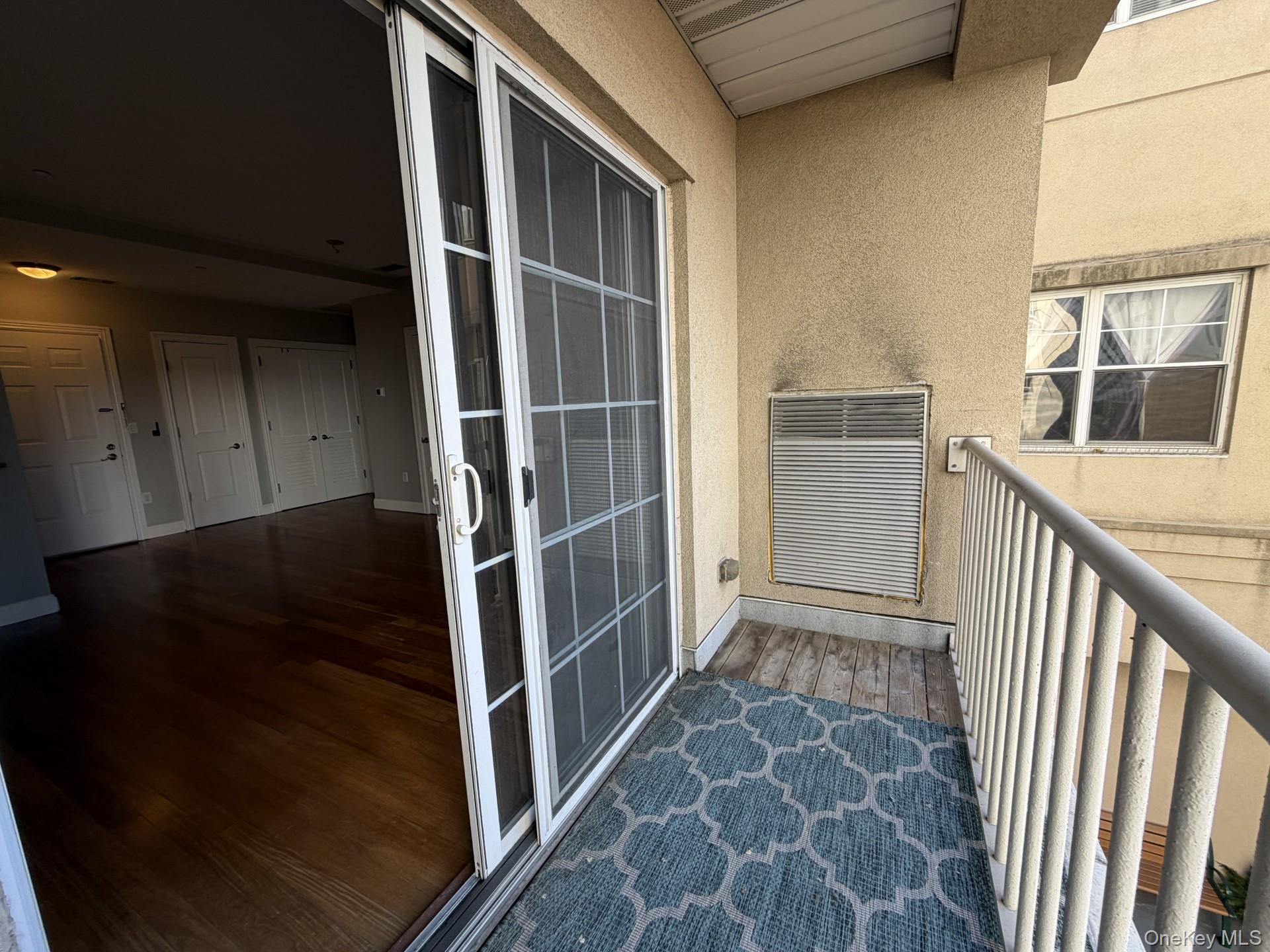 543 Main Street, Unit 204 New Rochelle, NY 10801 - Photo 3 of 17 a view of an empty room with wooden floor and a window
