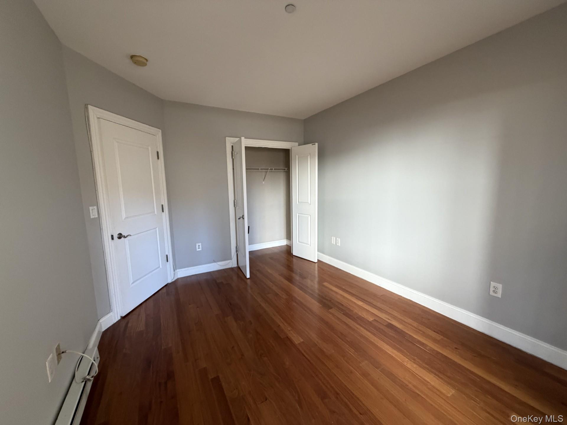 543 Main Street, Unit 204 New Rochelle, NY 10801 - Photo 5 of 17 a view of an empty room with wooden floor