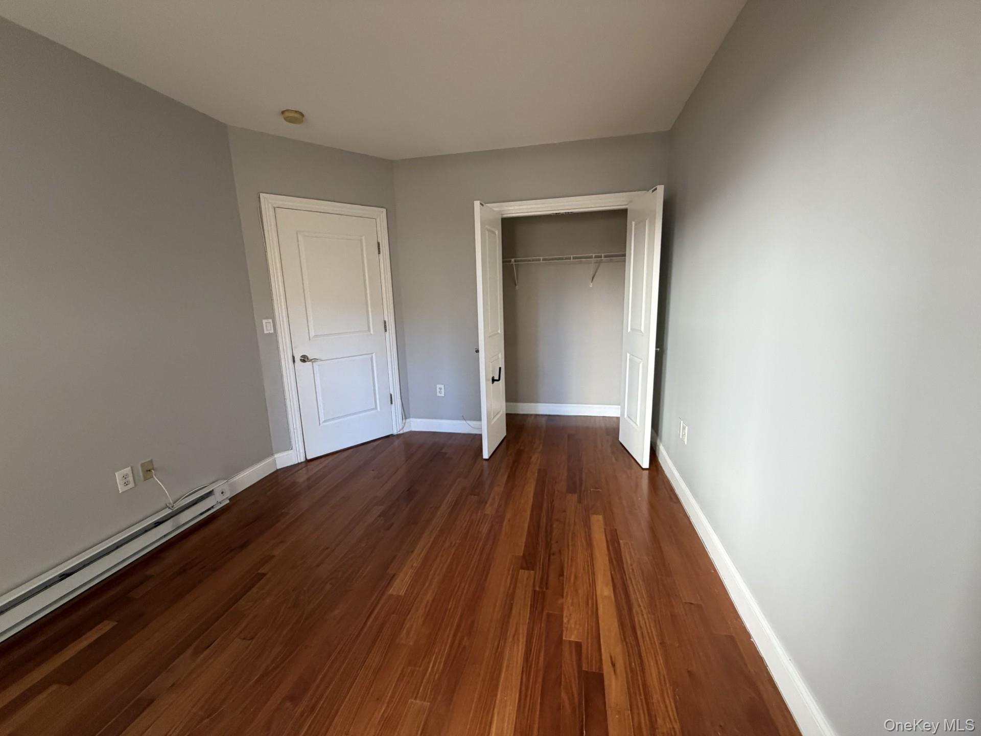 543 Main Street, Unit 204 New Rochelle, NY 10801 - Photo 6 of 17 a view of an empty room with wooden floor and closet