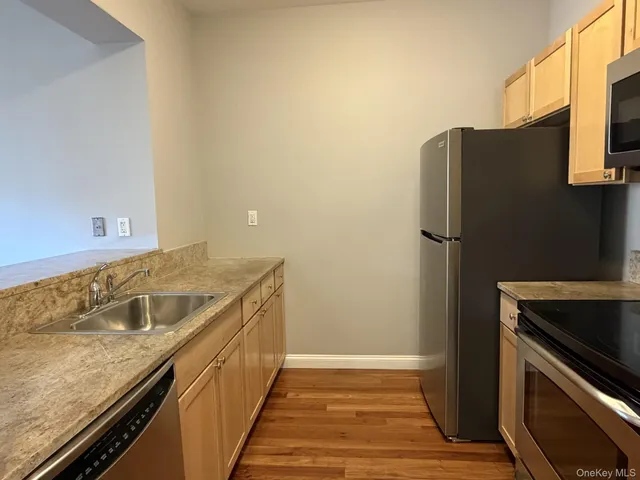 a kitchen with a refrigerator and a sink