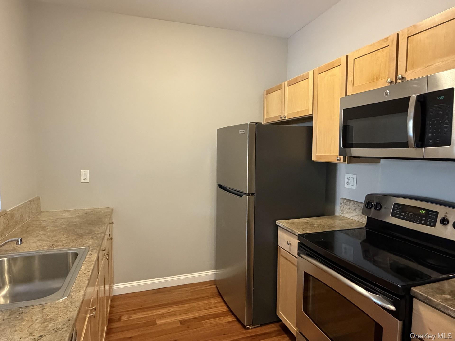 543 Main Street, Unit 204 New Rochelle, NY 10801 - Photo 8 of 17 a kitchen with a refrigerator stove and microwave