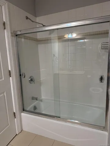 a bathroom with a shower and a bathtub