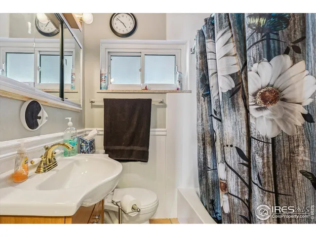 a bathroom with a toilet a sink and a mirror