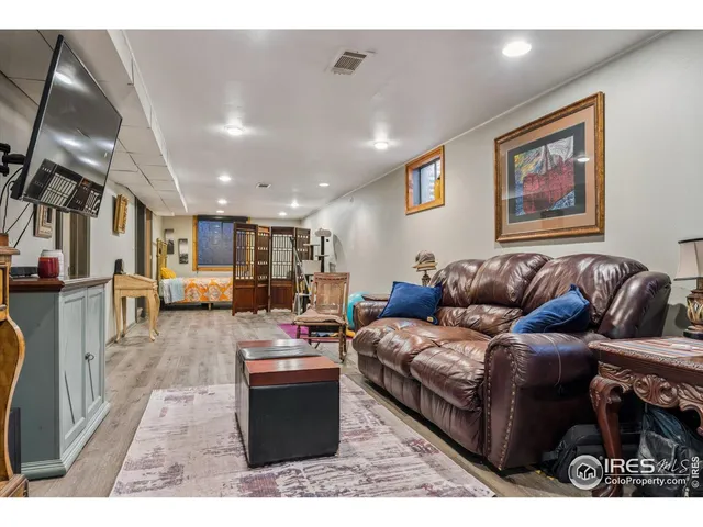 a living room with furniture kitchen view and a couch