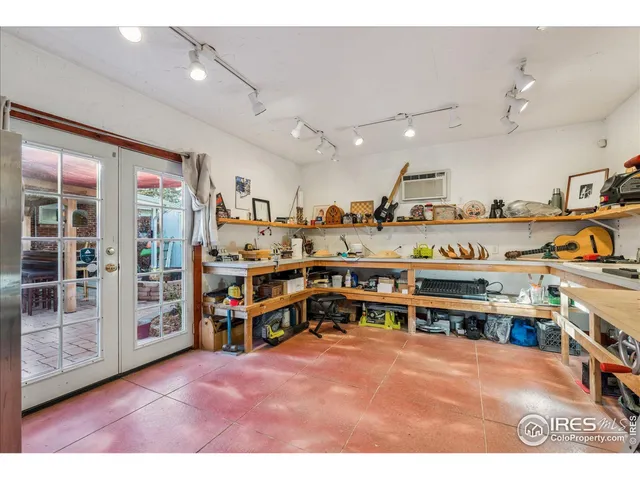 a view of a room with lots of furniture and clutter