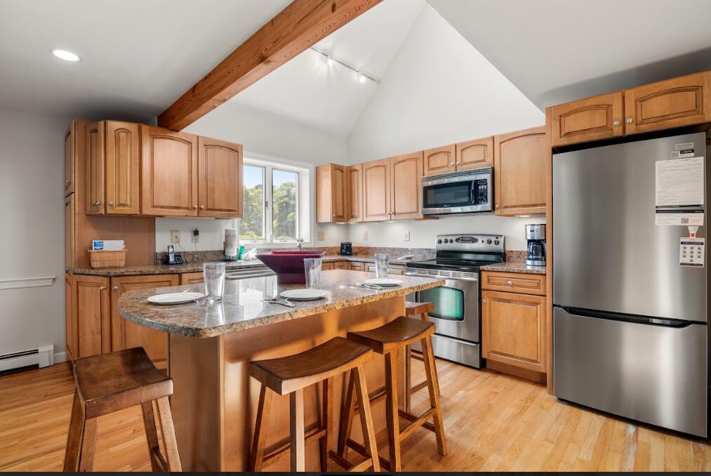 11 Fox Ridge Drive Orleans, MA 02653 - Photo 12 of 57 a kitchen with stainless steel appliances granite countertop a refrigerator stove microwave and sink